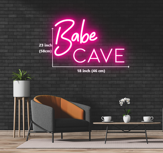 Neon sign reading 'Babe Cave' displayed on a brick wall, creating a vibrant and inviting atmosphere.