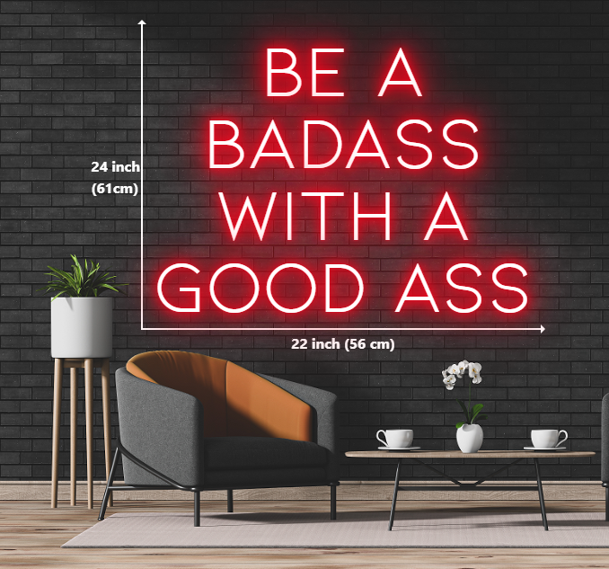 A neon sign with the words 'be a badass with a good ass' glowing in vibrant colors.